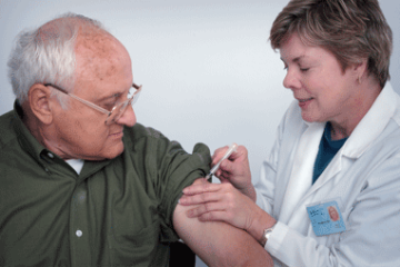 A certified nursing assistant (CNA) giving a patient an injection show her CNA skills